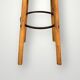 Old solid wood bar stool, metal footrest, green leatherette seat