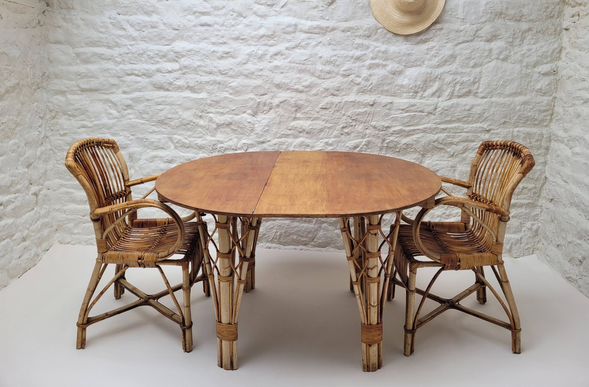 Vintage Audoux Minet bamboo, rattan, and smoked glass table duo.