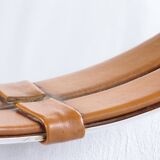 Round mirror covered with leather and chrome, made in France in the 1970s.