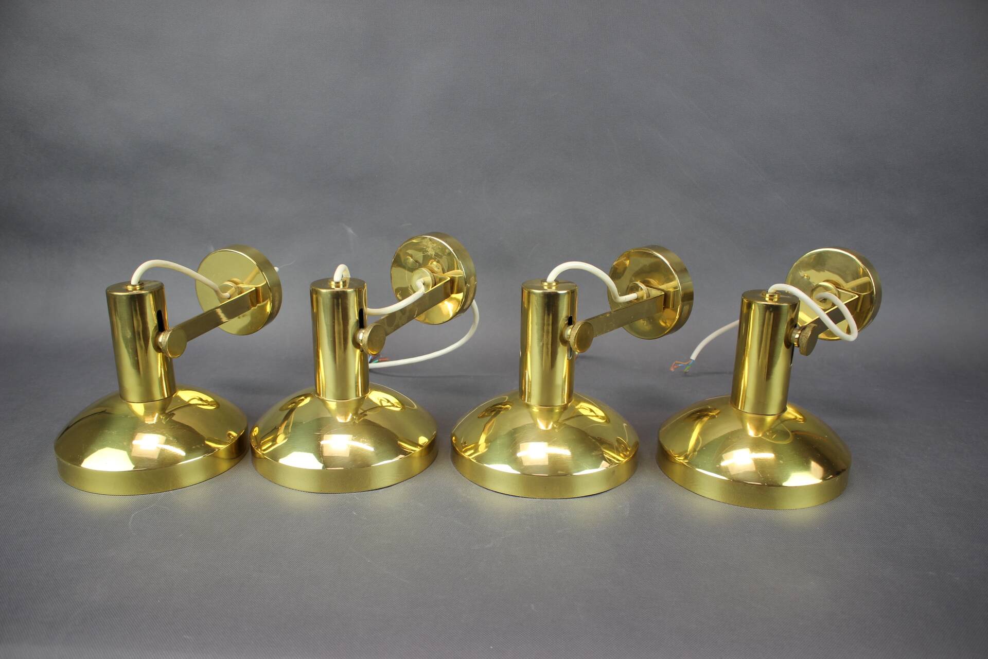 Set of four adjustable brass wall lights, Germany, 1960s.