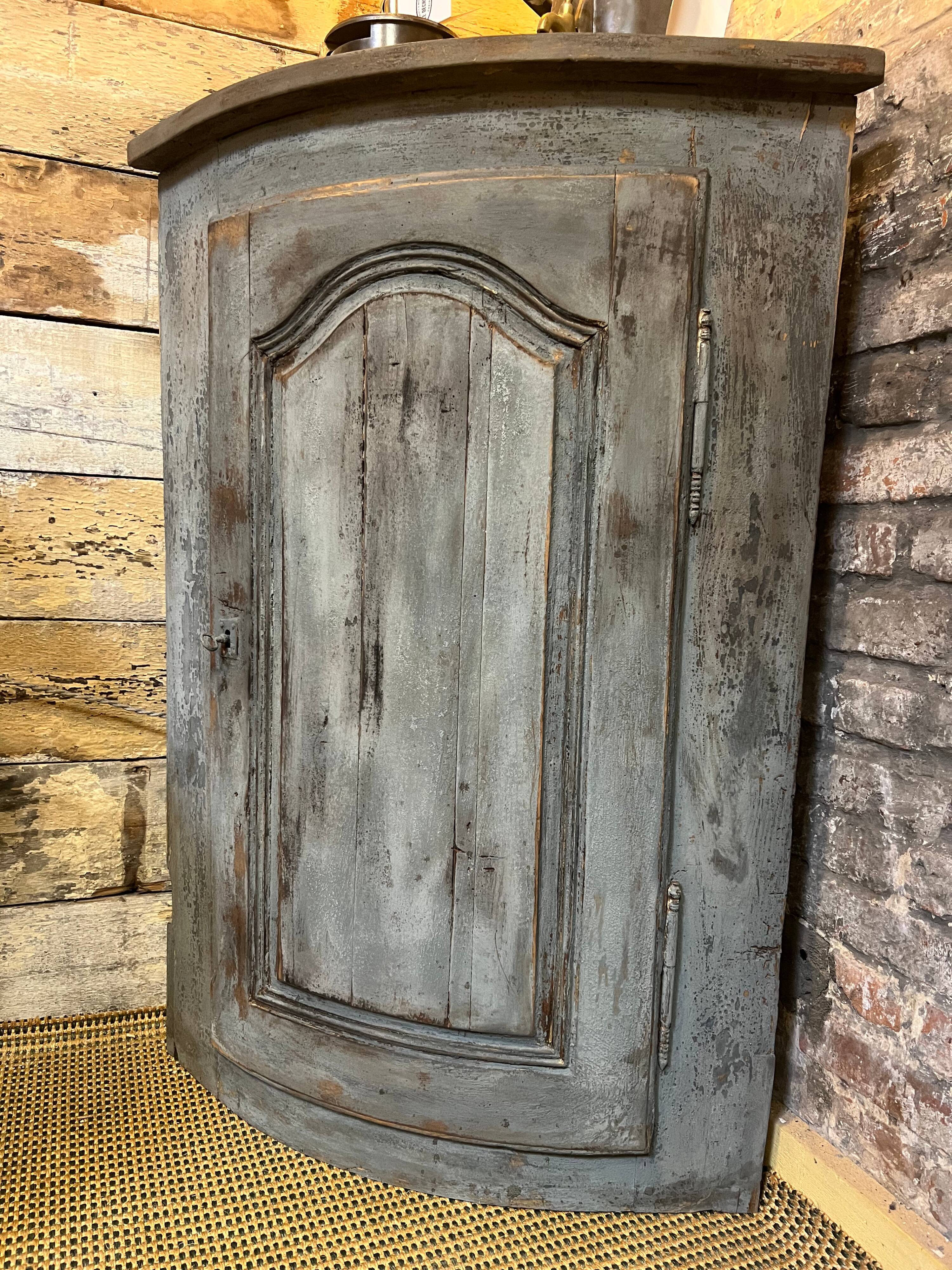 Eighteenth-century corner cabinet with a patina.