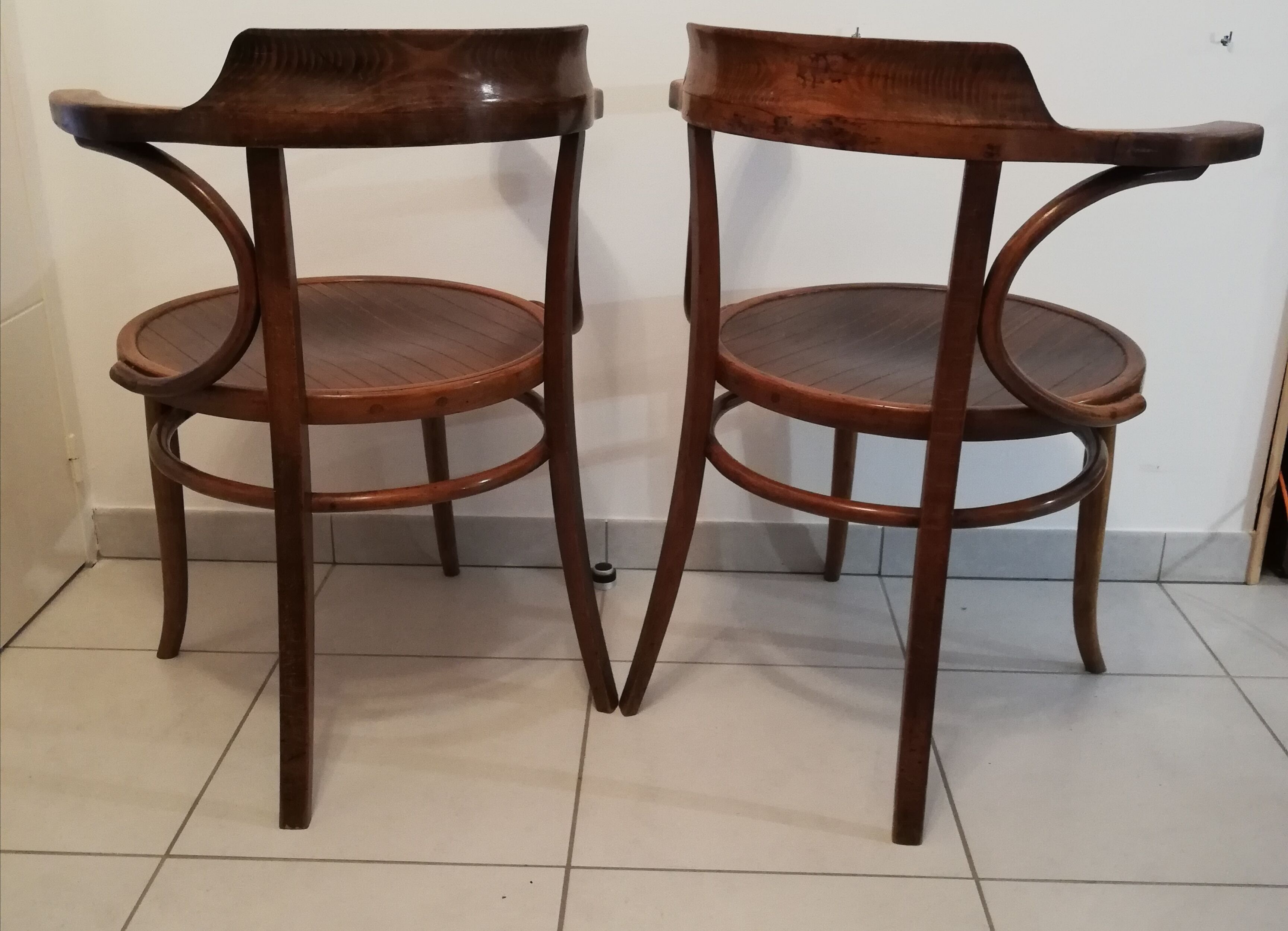 Pair of curved wooden armchairs