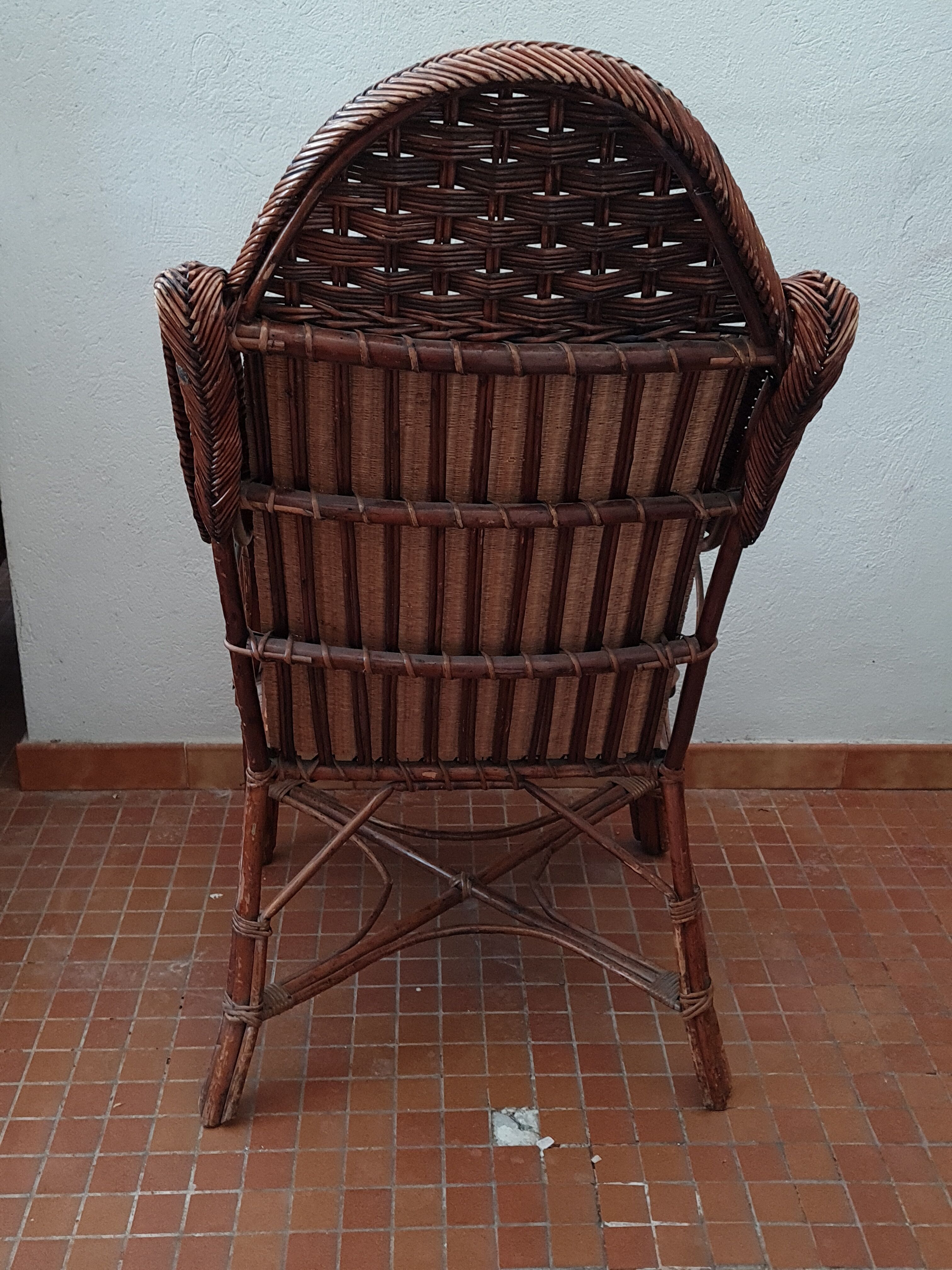 Old rattan armchair circa 1900-1930