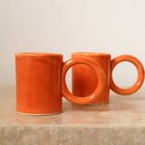 Handmade orange peach ceramic coffee mug set with large circular handles
