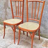 Pair of wooden and cane bistro chairs
