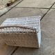 Vintage white wicker chest with double lid and decorative weaving.