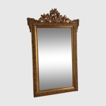 Late 19th century gilded mirror with decorated pediment. 140x88.