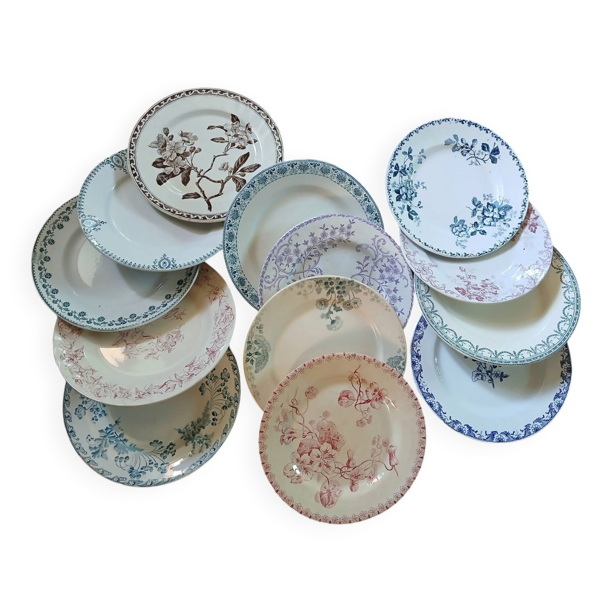 13 mismatched flat plates in ironstone
