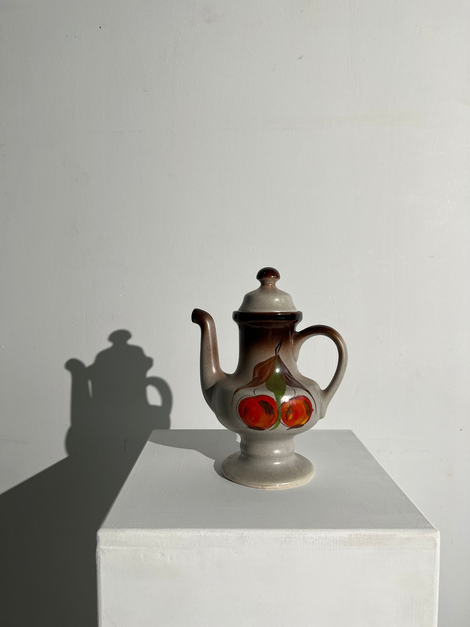 Vintage stoneware teapot with flower and fruit patterns