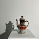 Vintage stoneware teapot with flower and fruit patterns