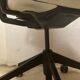 Office chair with wheels and mesh backrest.