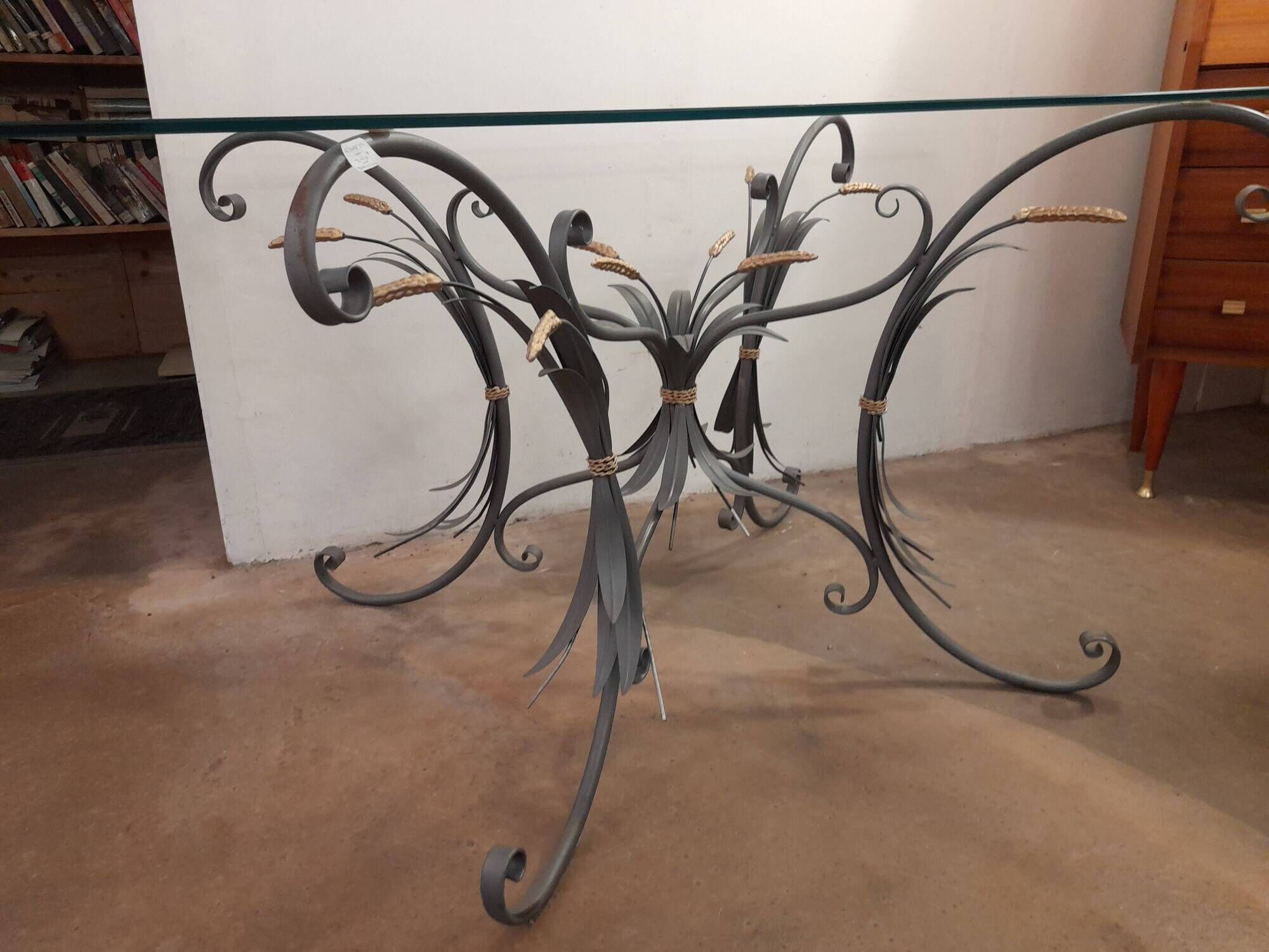 Glass top table with iron base in the style of wheat ears. Attributed to Robert Goossens.