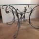 Glass top table with iron base in the style of wheat ears. Attributed to Robert Goossens.