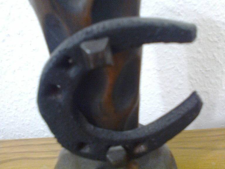 Carved turned wooden vase for dry flowers, decorated with a small horseshoe