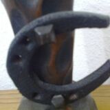 Carved turned wooden vase for dry flowers, decorated with a small horseshoe