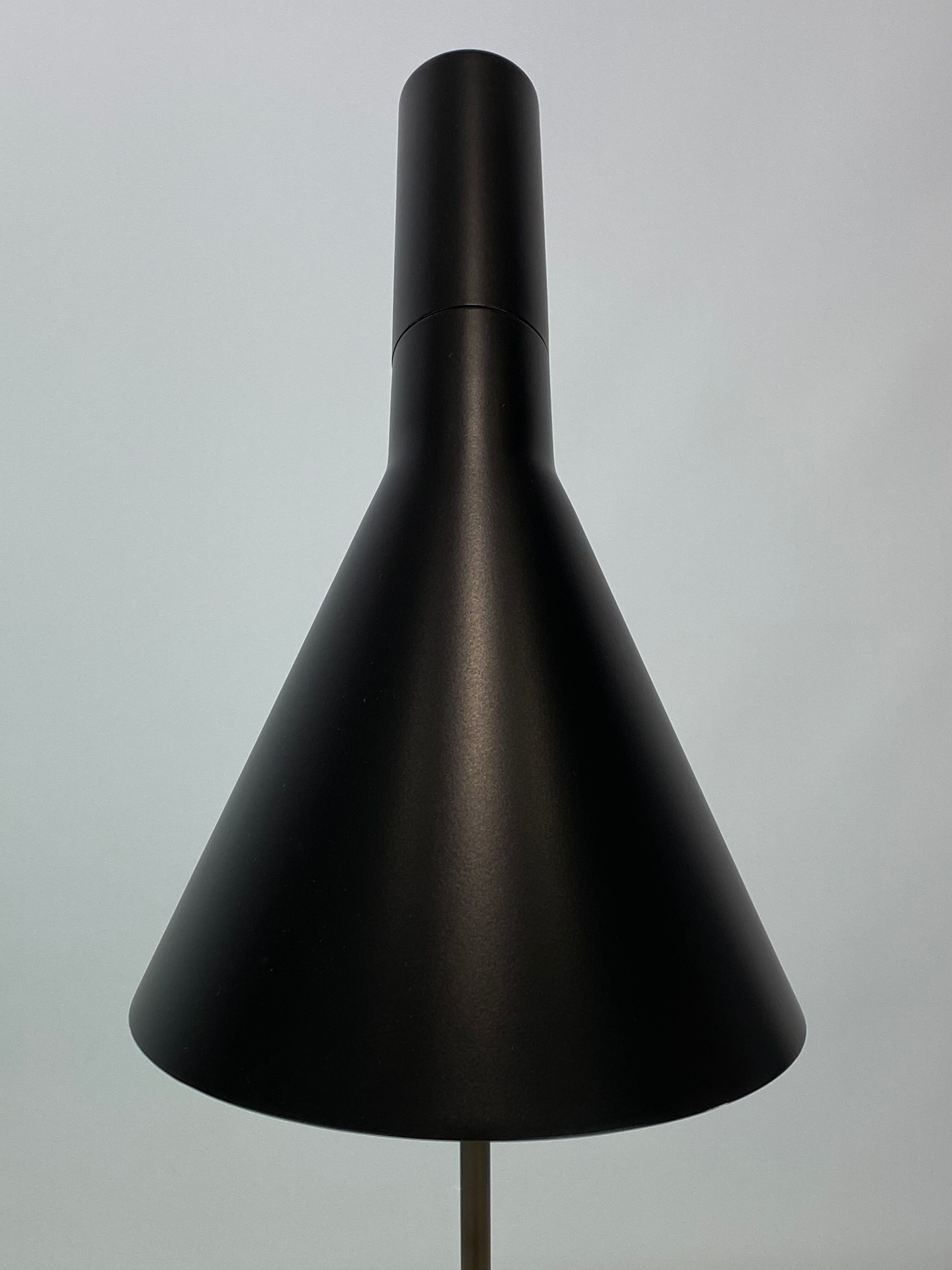 Black table lamp designed by Arne Jacobsen and manufactured by Louis Poulsen