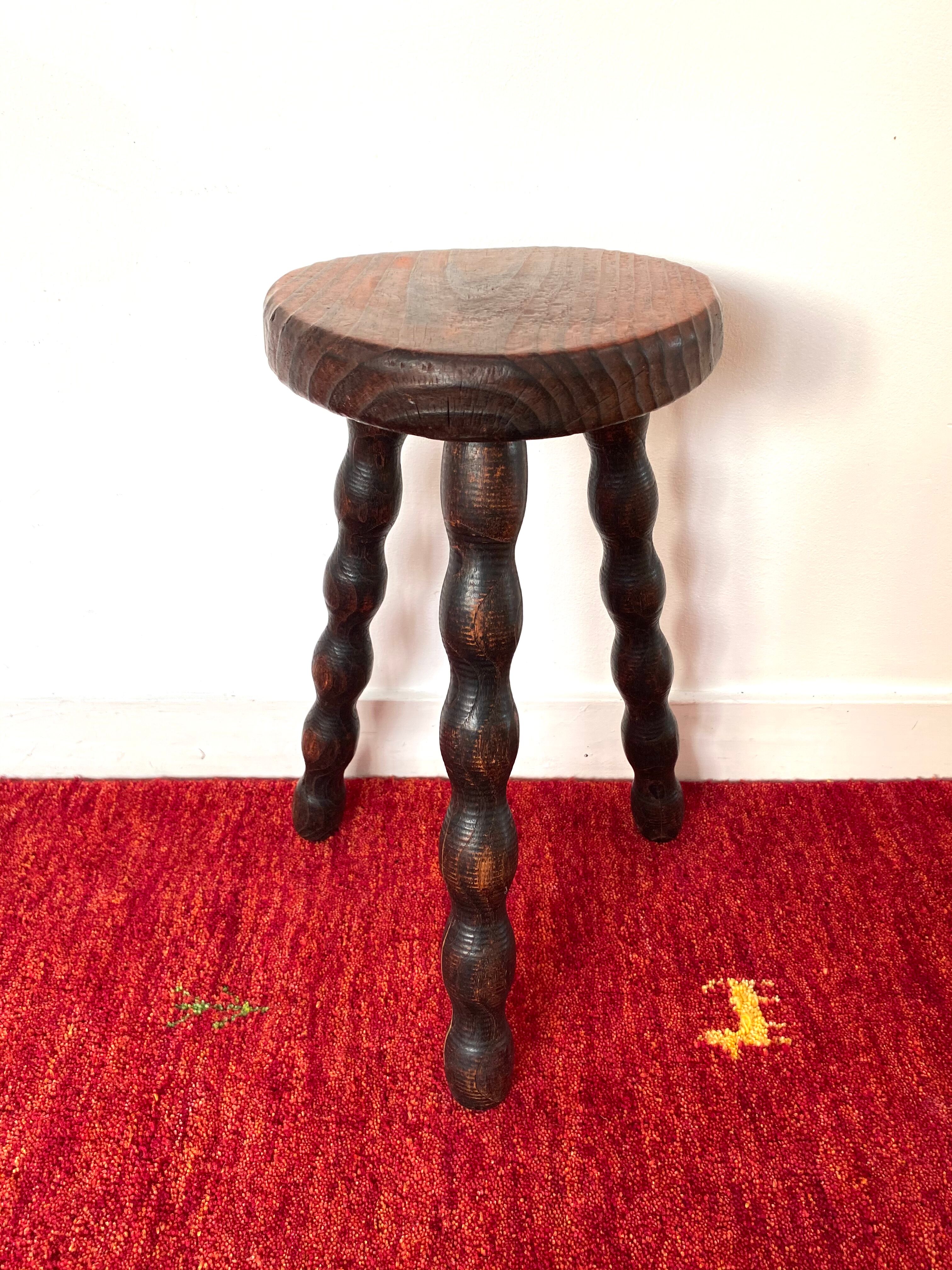 Old tripod stool in solid wood