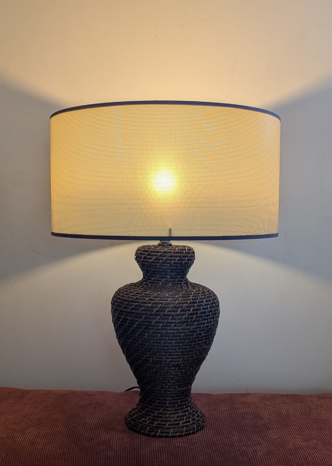 Vintage lamp in brown rattan with textured lampshade.
