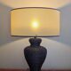 Vintage lamp in brown rattan with textured lampshade.