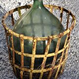 Demijohn in his iron cager