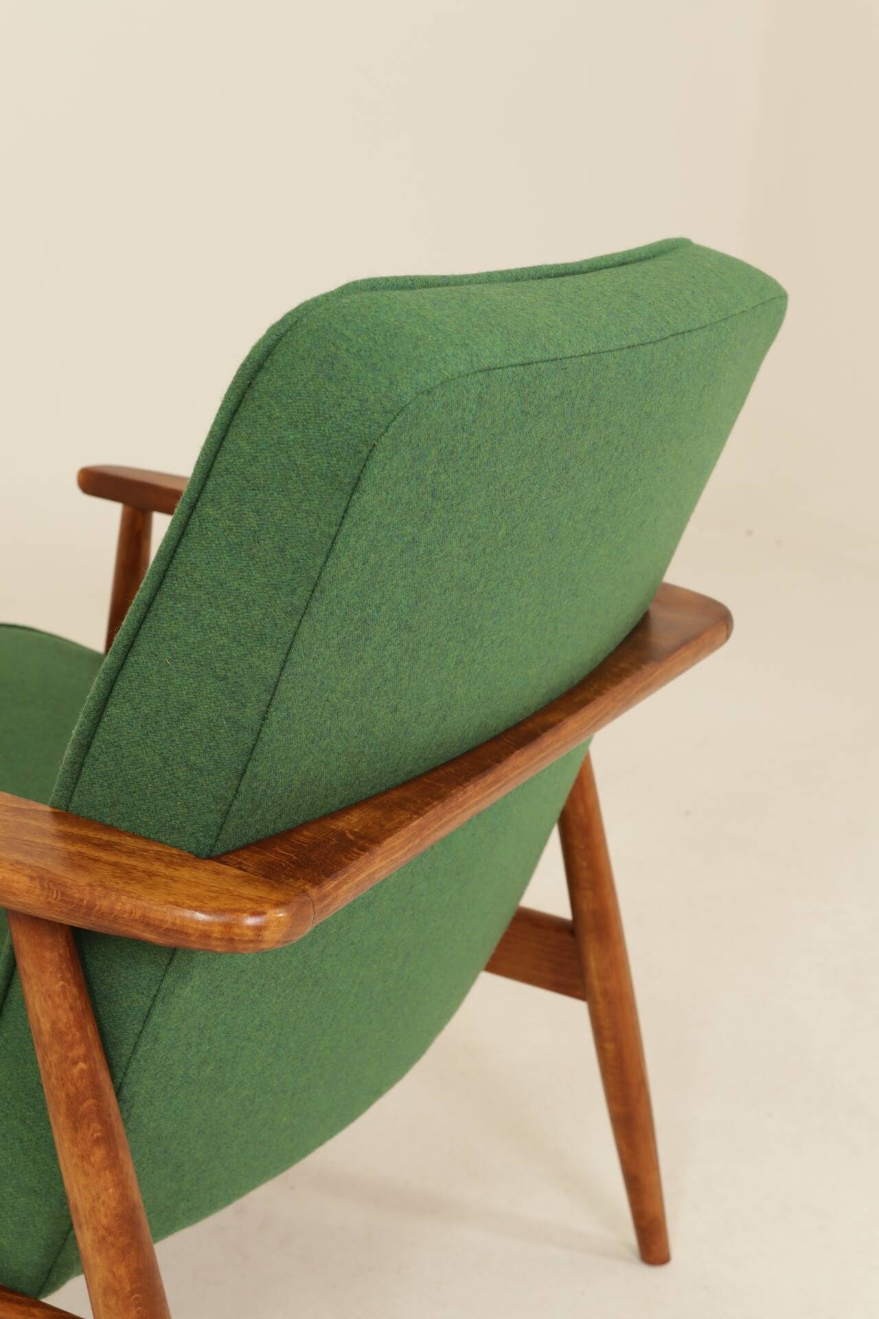 Scandinavian modern chair in green wool, vintage wooden armchair.