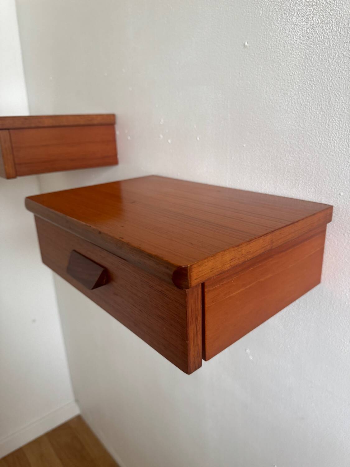 Vintage Scandinavian teak wall-mounted bedside tables.