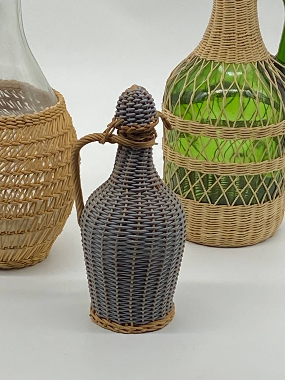 Trio bottles / lady Jeanne, dressed in wicker, rattan, natural fibers