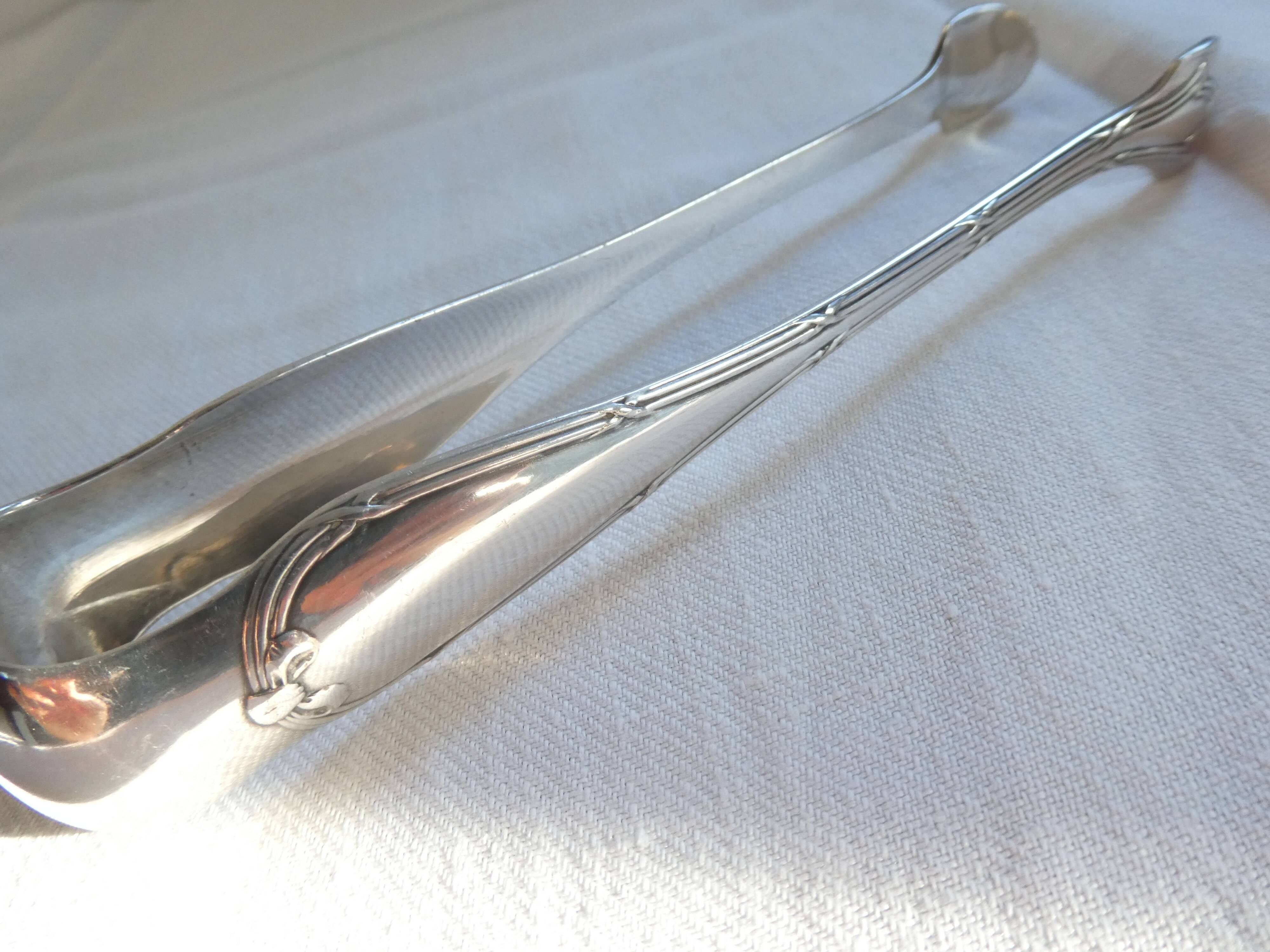 Christofle Silver-plated metal sugar tongs with crossed ribbon bow design