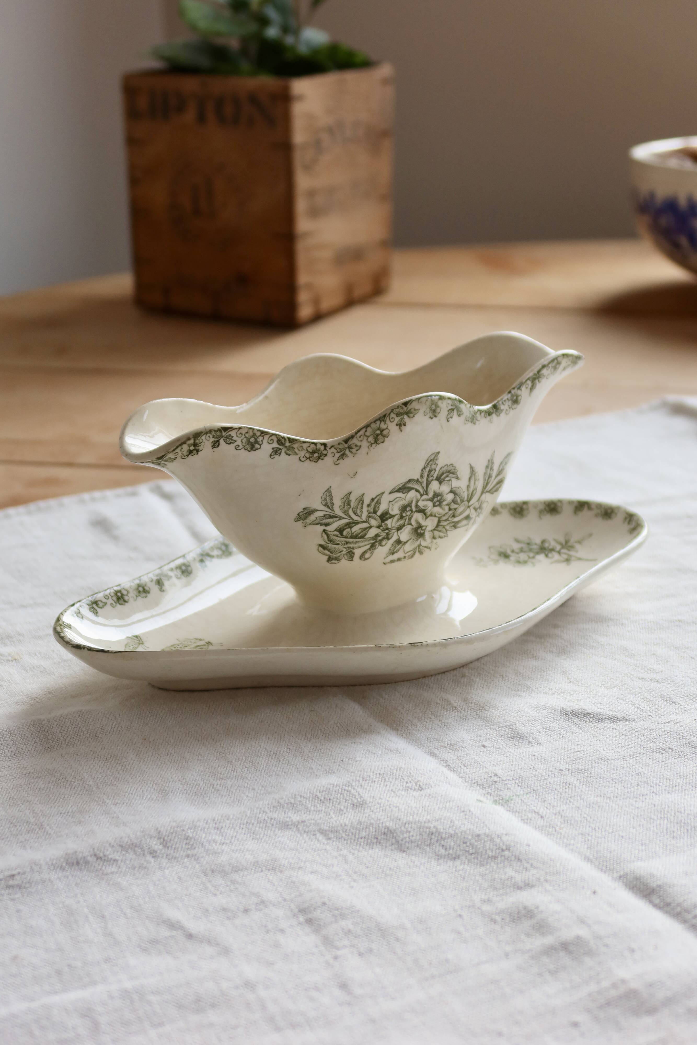 Antique sauce boat, ironstone, ivory with green floral and butterfly decoration.