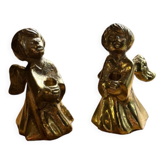 Pair of brass cherub candle holders