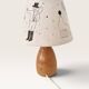 Wood-turned lamp with a hand-drawn lampshade, circus patterns.