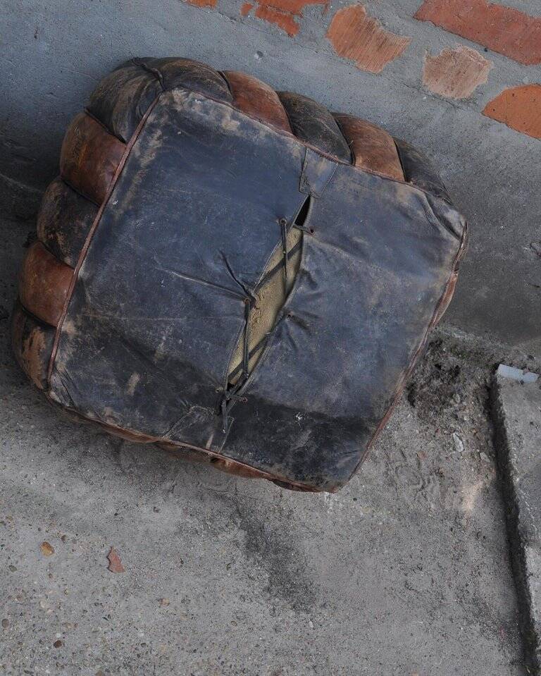 Set of 2 vintage ottomans in brown and black leather with Egyptian patterns from the 1970s.