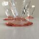 Lot of water in white and pink glass glasses