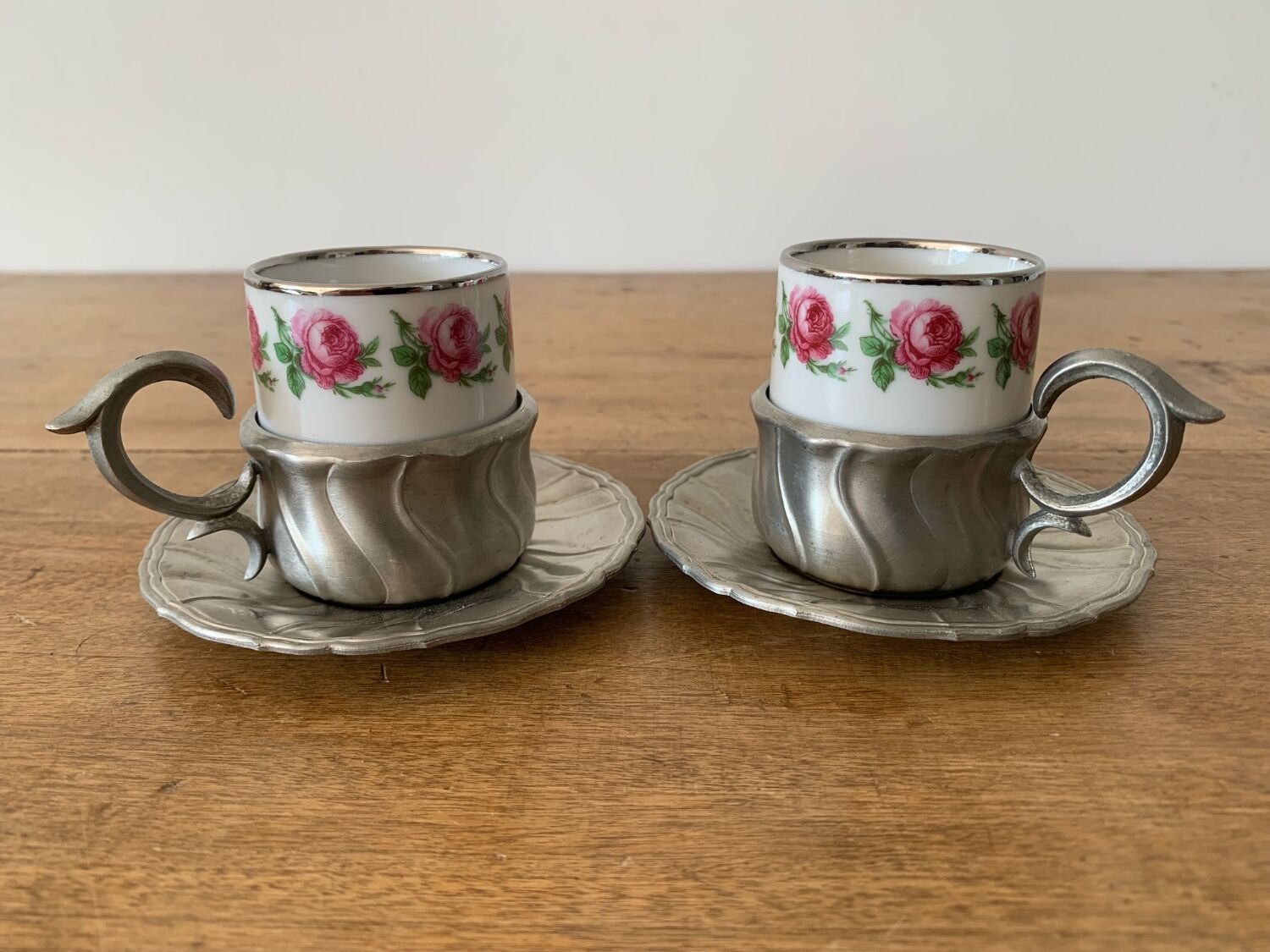 2 small porcelain cups and their pewter cup holders