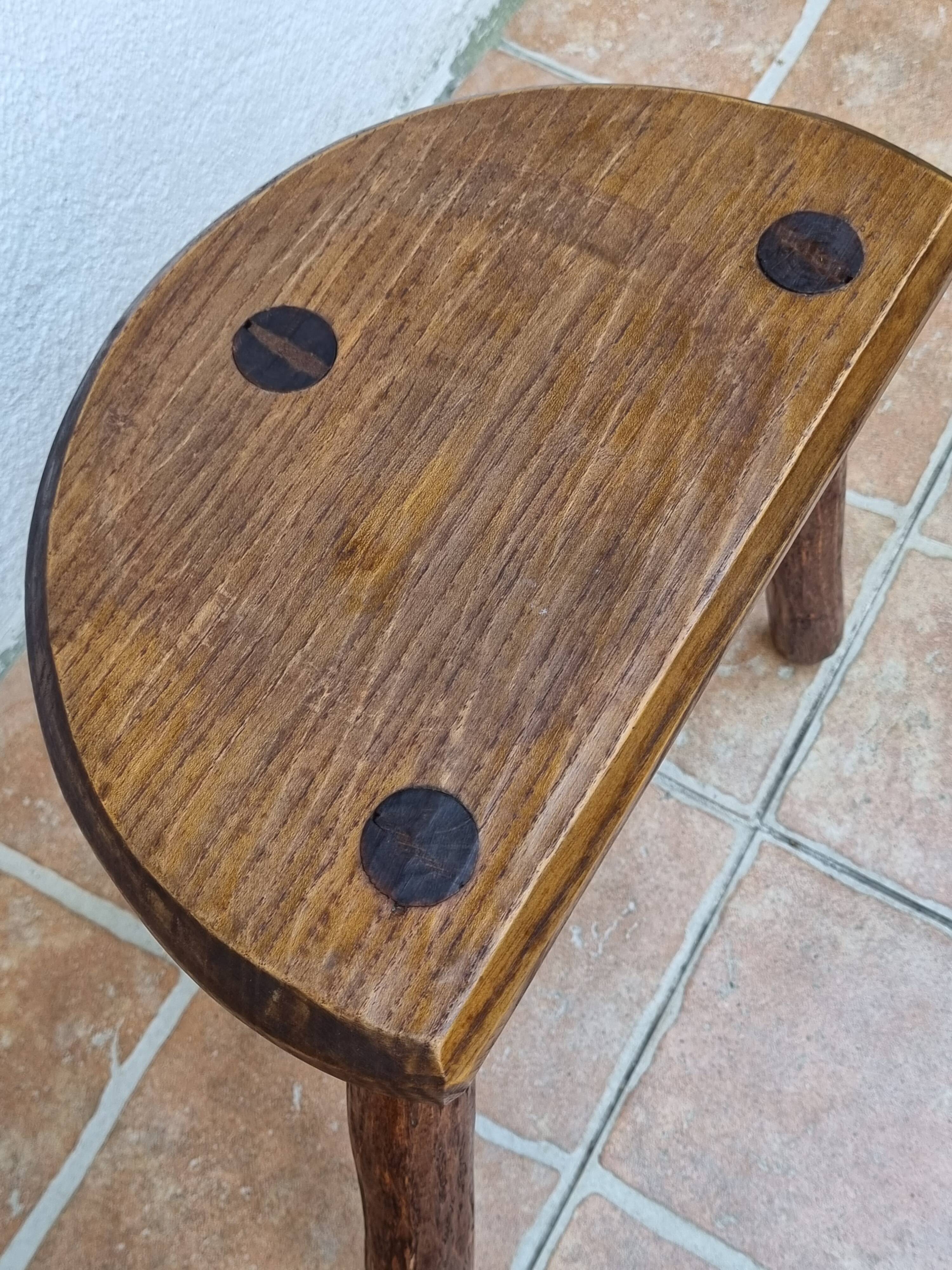 Pair of rustic tripod stools in solid wood, brutalist style.