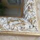 Pair of bevelled mirrors in white and gilded wood 86 x 66 cm