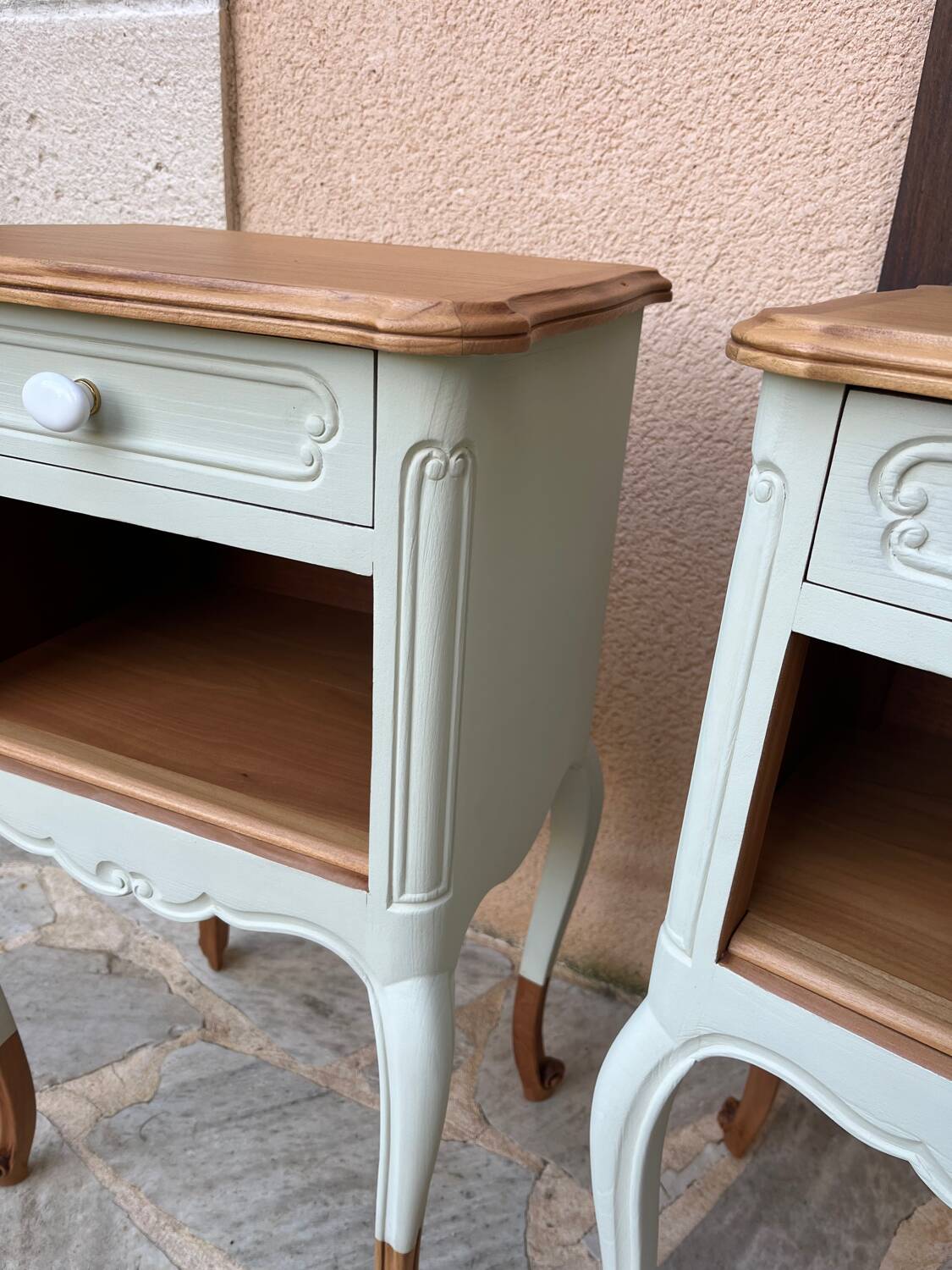 Renovated bedside tables in laurel green and light wood.