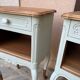 Renovated bedside tables in laurel green and light wood.