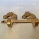 Wall-mounted coat rack with horses in brass
