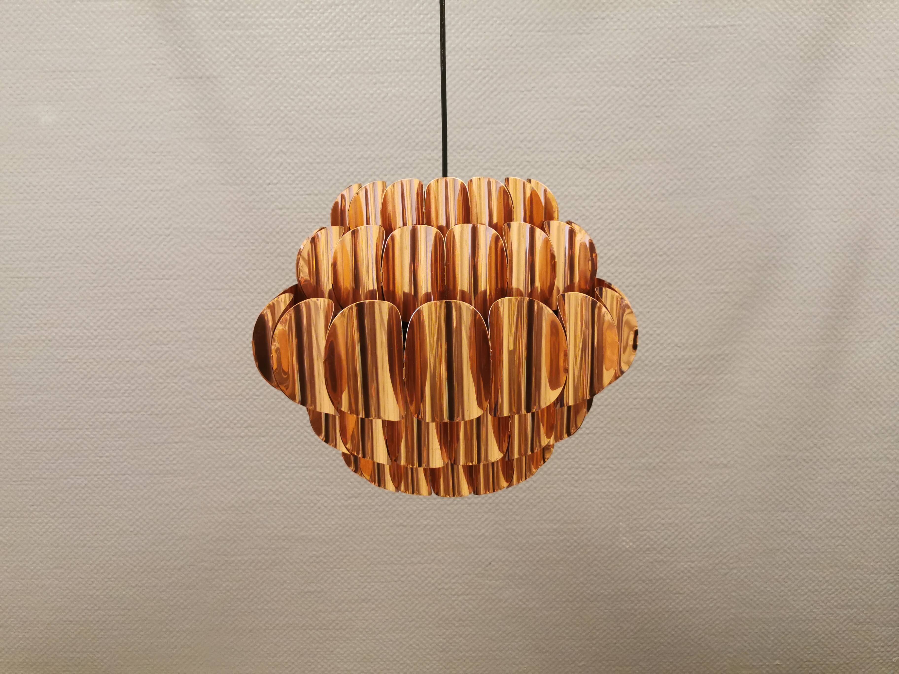 Copper colored hanging lamp. designed by thorsten orrling sweden