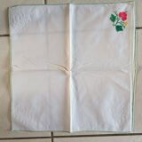Large white map with colored flower insertion and embroidery.