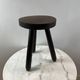 Tripod stool in turned, patinated wood