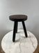 Tripod stool in turned, patinated wood