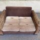 Exotic 2-seater sofa in woven banana tree / rattan and brown fabric.