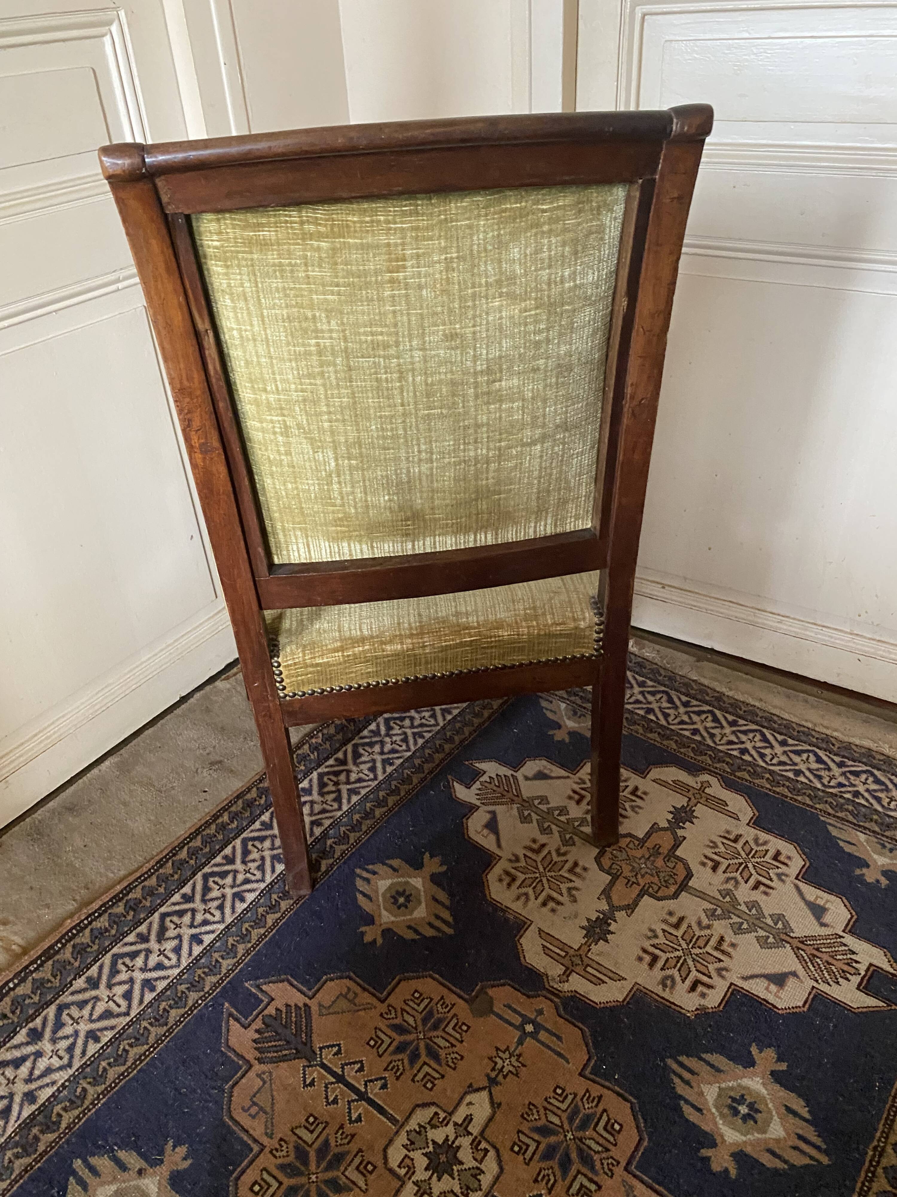 Armchair with a scroll, upholstered in green velvet