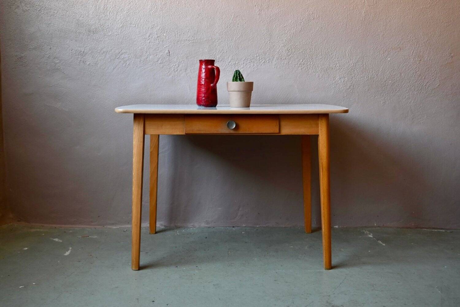1950s Formica kitchen table with tapered legs and vintage drawer.