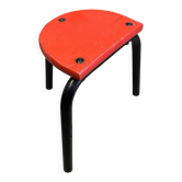 Red tripod stool in industrial style