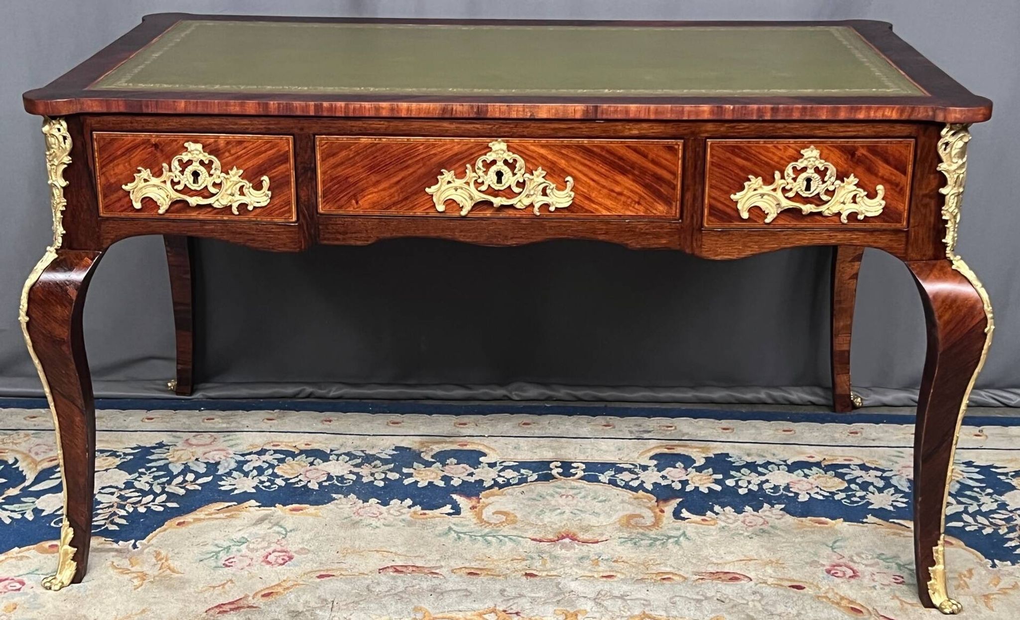 Louis XV style desk. Rosewood veneer, gilt bronze decoration, leather.