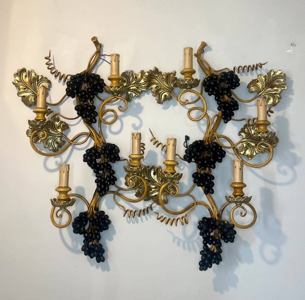 Large pair of wall sconces with vine decorations.