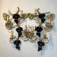 Large pair of wall sconces with vine decorations.
